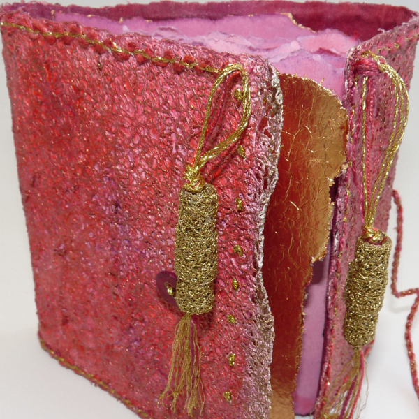 Hand-stitched textile book with gold thread